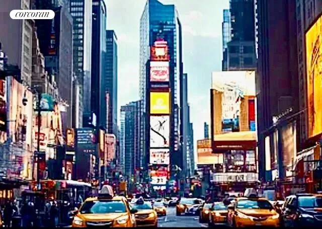 a city street filled with lots of traffic and tall building