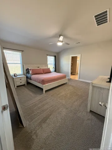 a bedroom with a bed and a couch