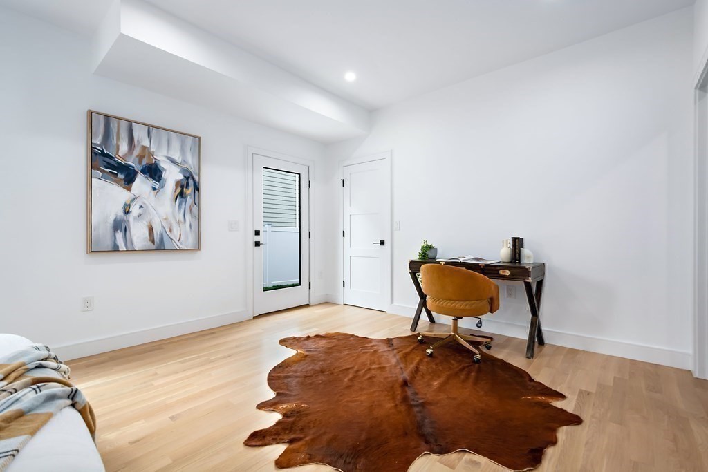 25 Tolman Street, Unit 1 Waltham, MA 02453 - Photo 22 of 36 a room with furniture and a rug
