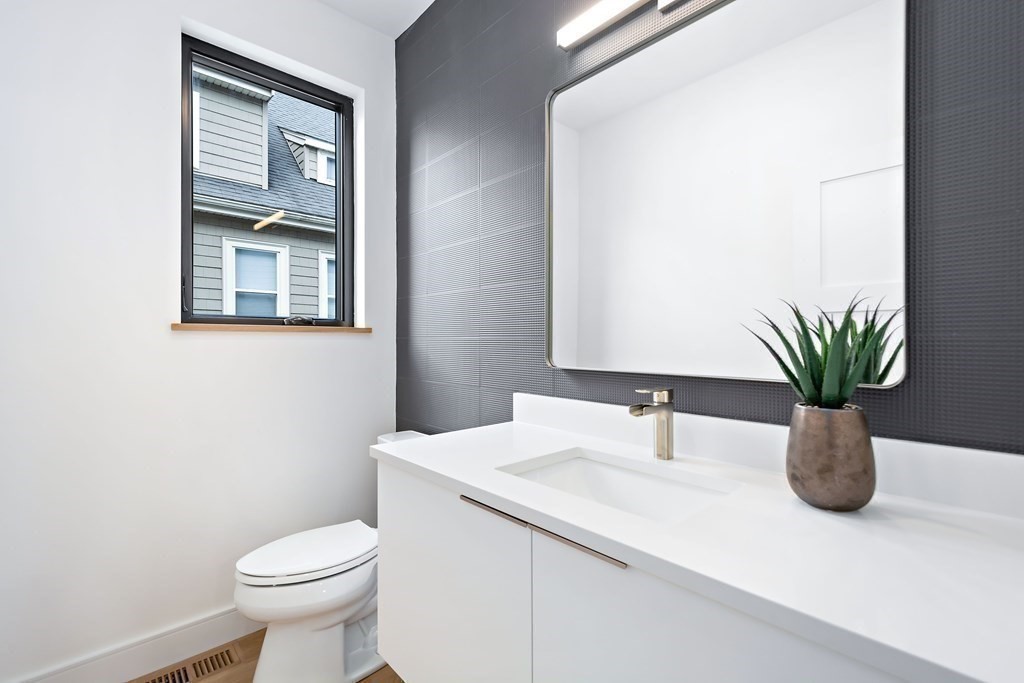 25 Tolman Street, Unit 1 Waltham, MA 02453 - Photo 27 of 36 a white sink sitting next to a white toilet
