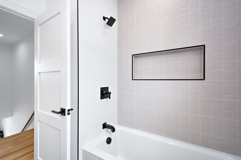 25 Tolman Street, Unit 1 Waltham, MA 02453 - Photo 28 of 36 a bathroom with a bathtub