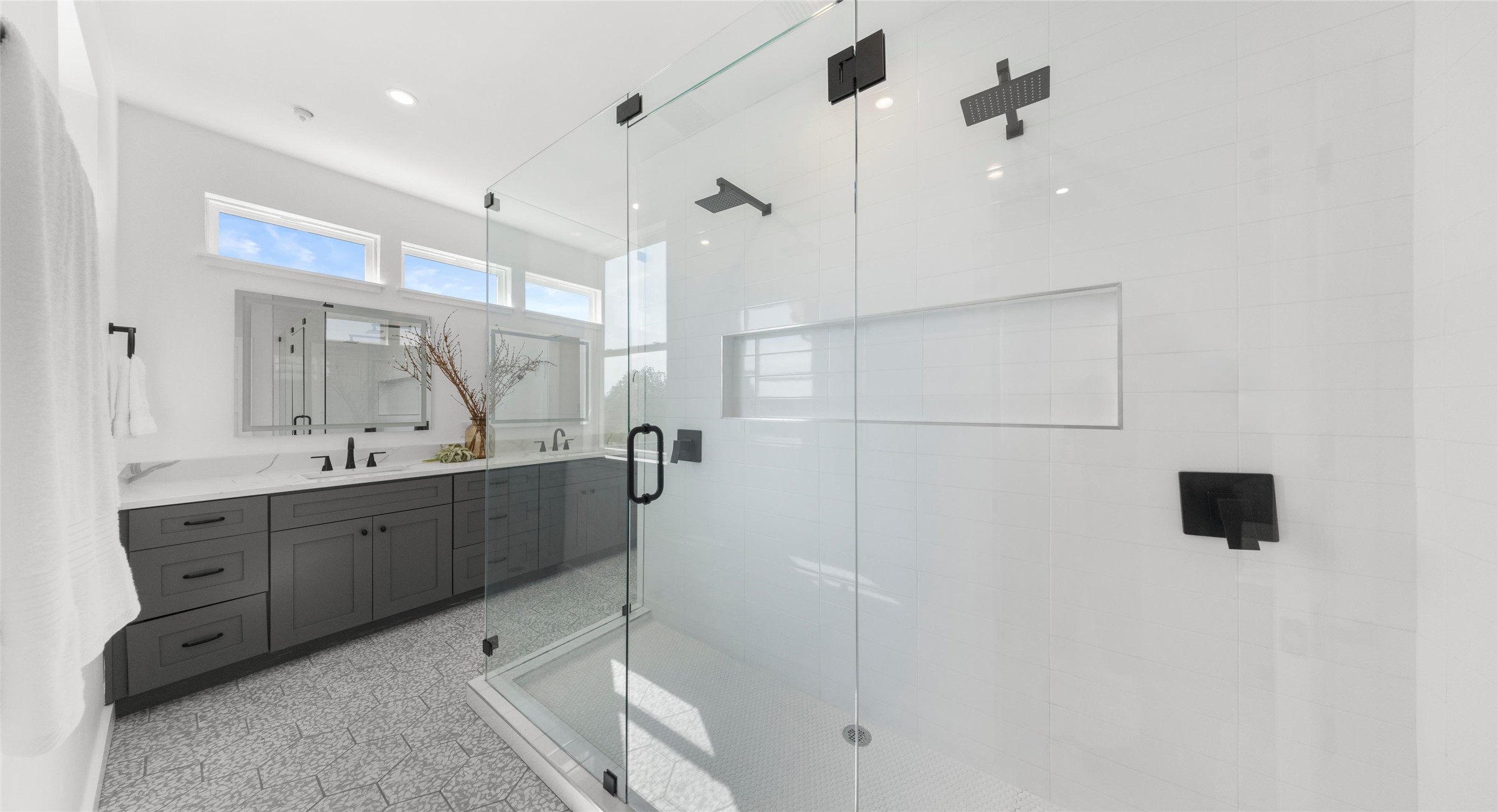 5912 Harold Court, Unit 107 Austin, TX 78721 - Photo 24 of 35 A light-filled primary bath beneath a vaulted ceiling, with a walk-in shower made for unwinding. Model No. 105 Shown.