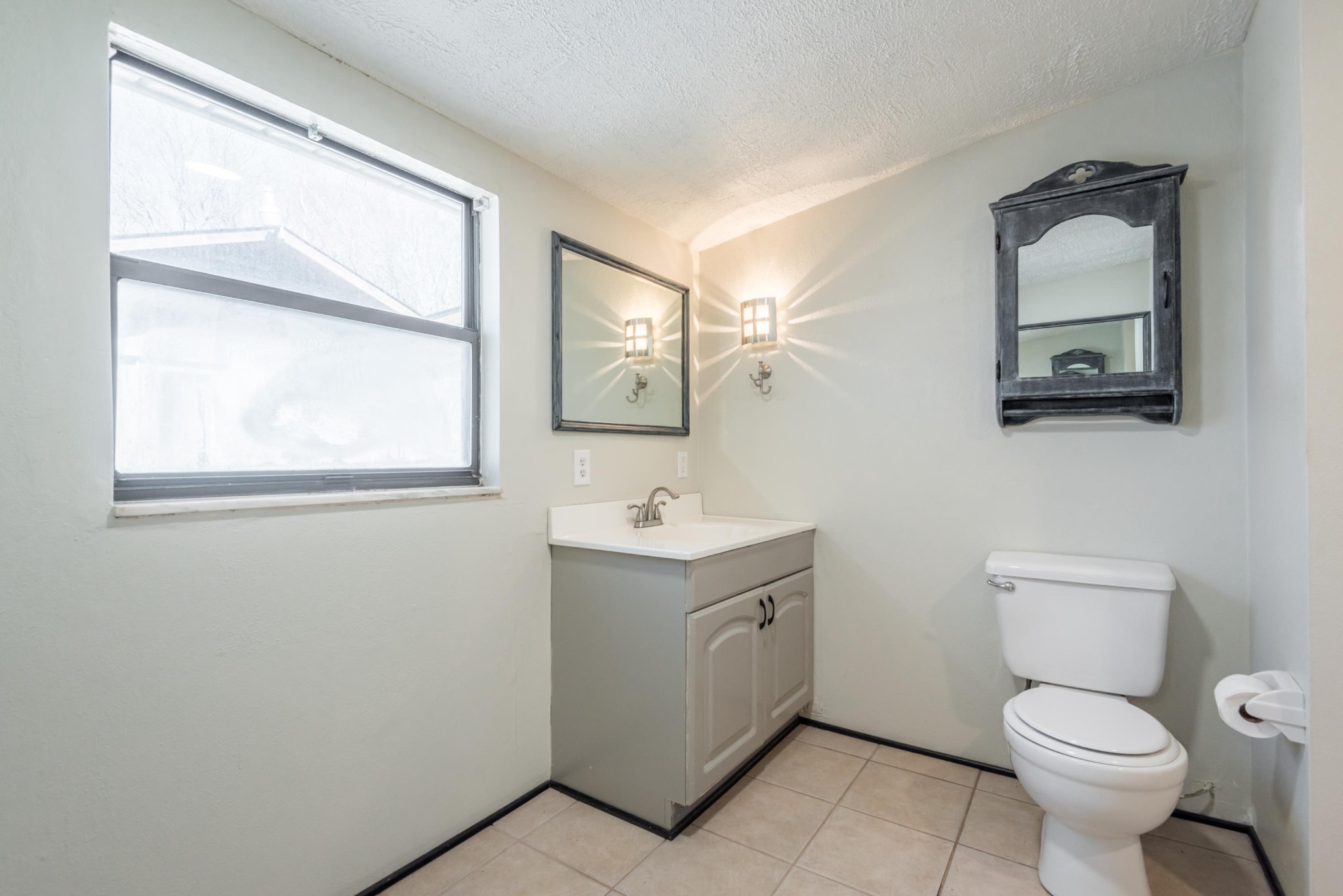 6313 Ridgeview Road Knoxville, TN 37918 - Photo 18 of 33 a bathroom with a toilet sink vanity and mirror