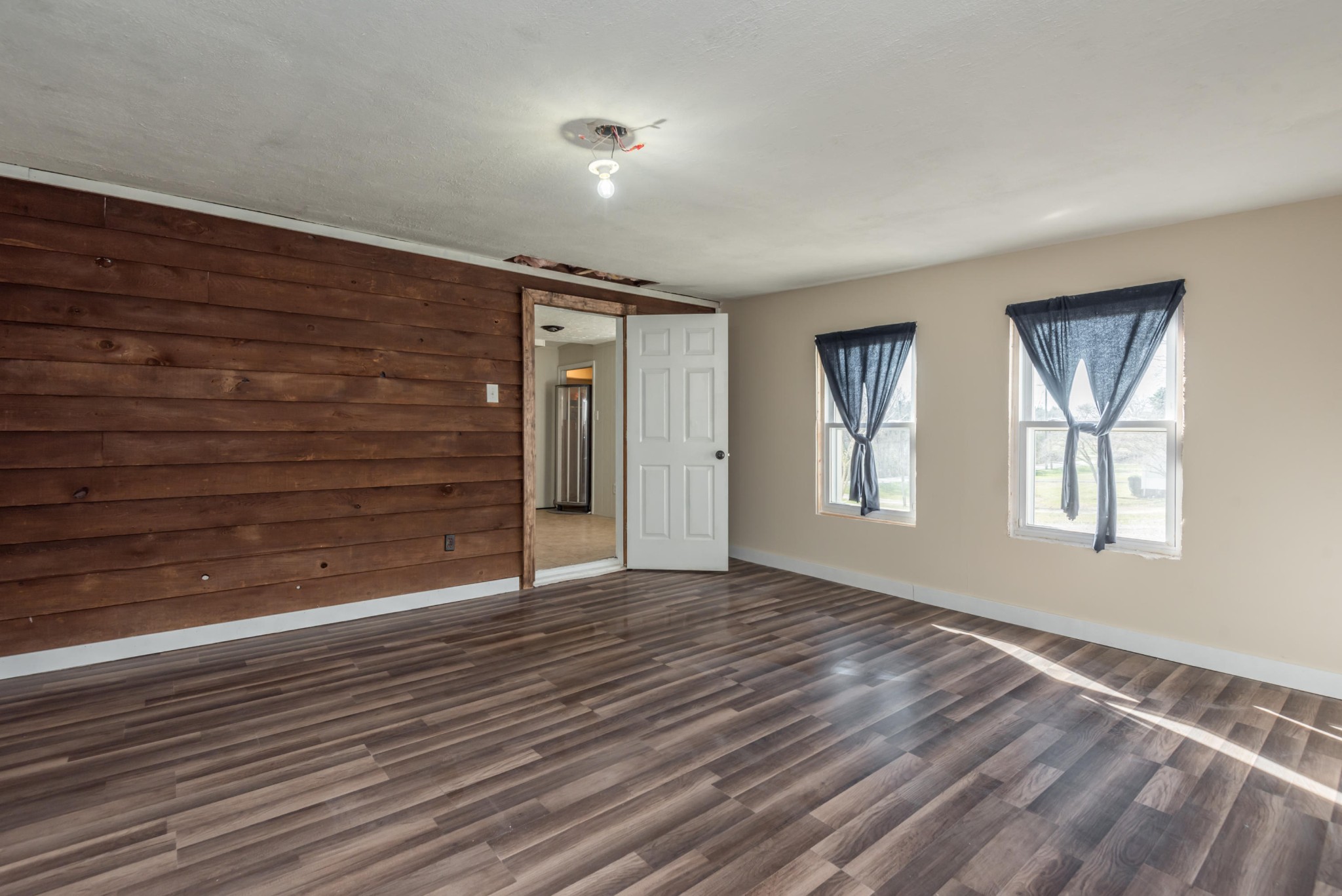 6313 Ridgeview Road Knoxville, TN 37918 - Photo 21 of 33 a view of an empty room with wooden floor and a window