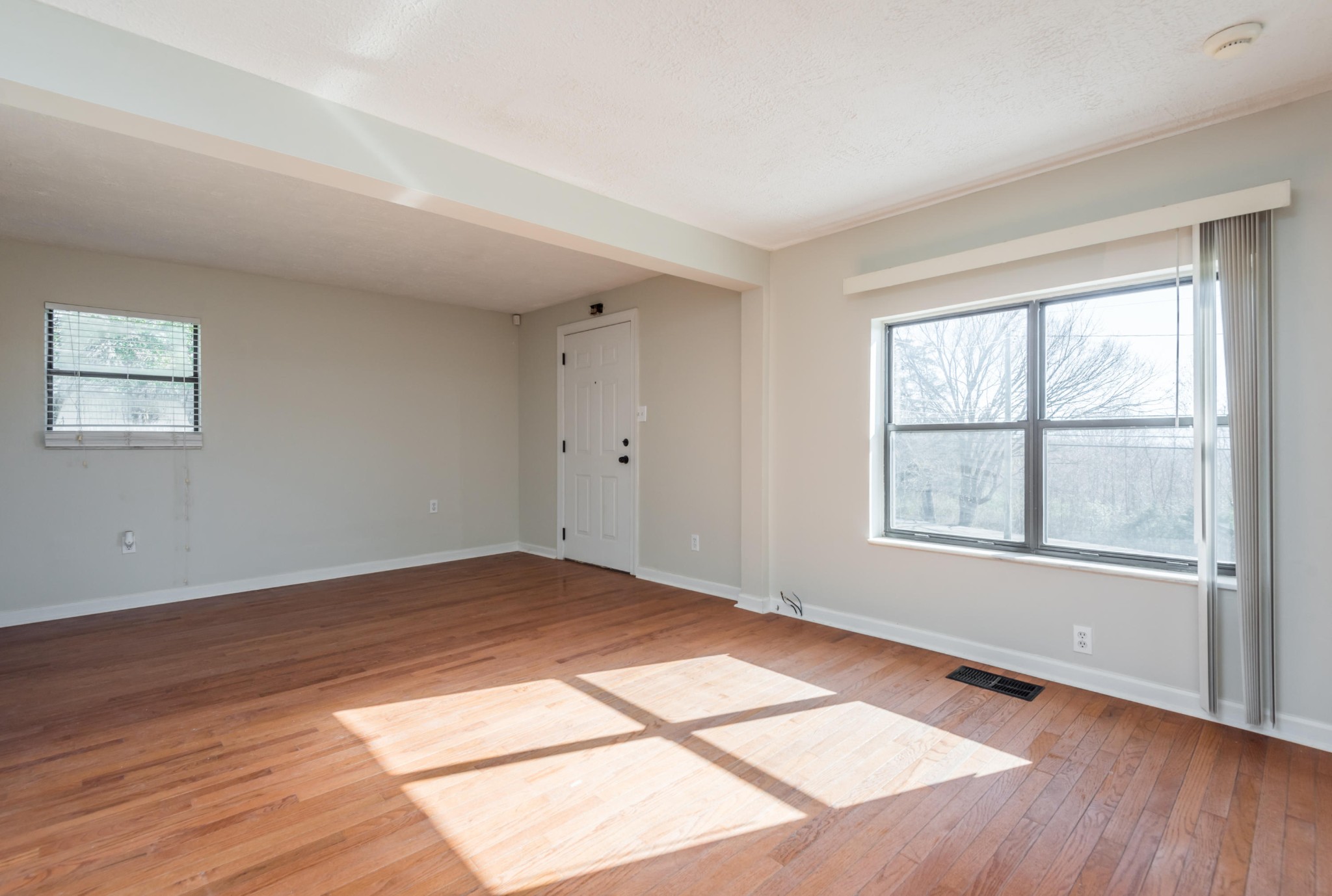 6313 Ridgeview Road Knoxville, TN 37918 - Photo 5 of 33 an empty room with wooden floor and windows
