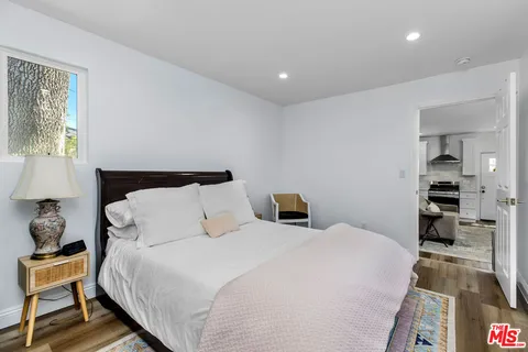 a bedroom with a bed and a book shelf
