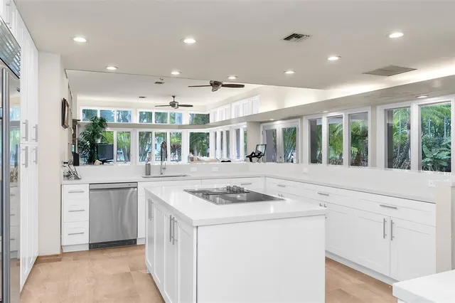 a bedroom with a bed next to a window with a dresser