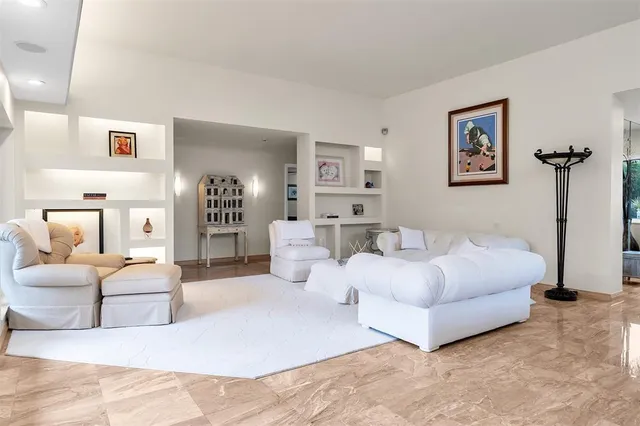 a living room with furniture and floor to ceiling windows