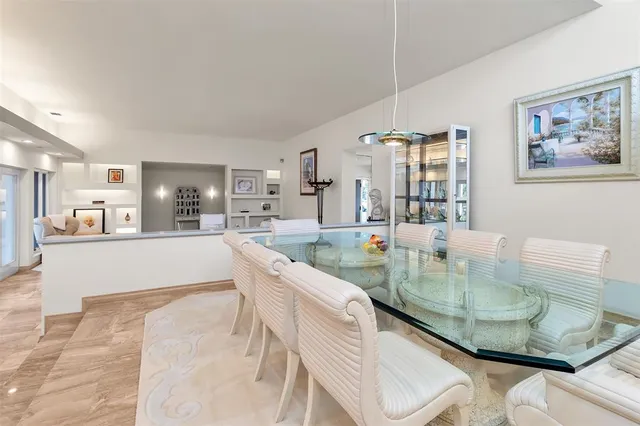 a large white kitchen with a large window and stainless steel appliances