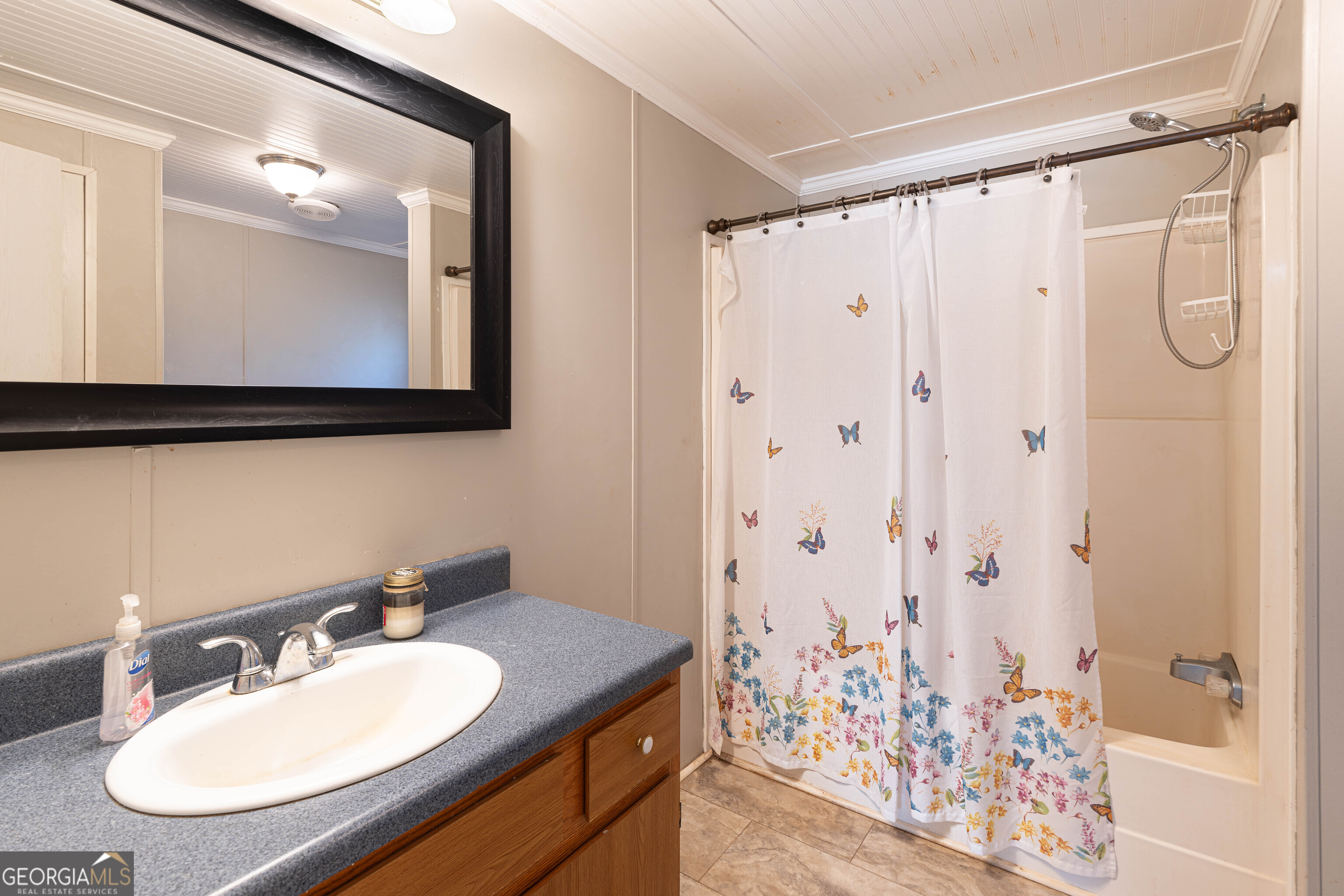 161 Cherokee Trail Forsyth, GA 31029 - Photo 19 of 32 a bathroom with a granite countertop sink a mirror a shower and a bathtub