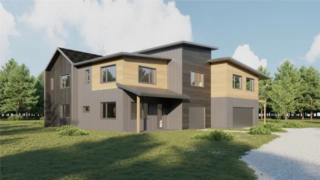 a front view of a house with a garden and yard