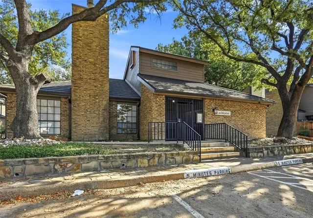 a kitchen with white cabinets and appliances