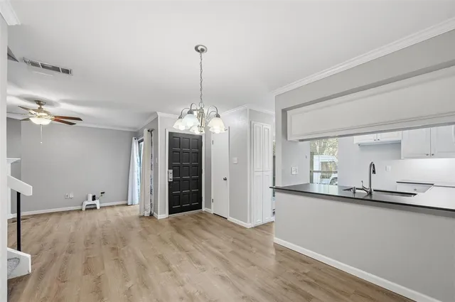 an empty room with windows and a fireplace