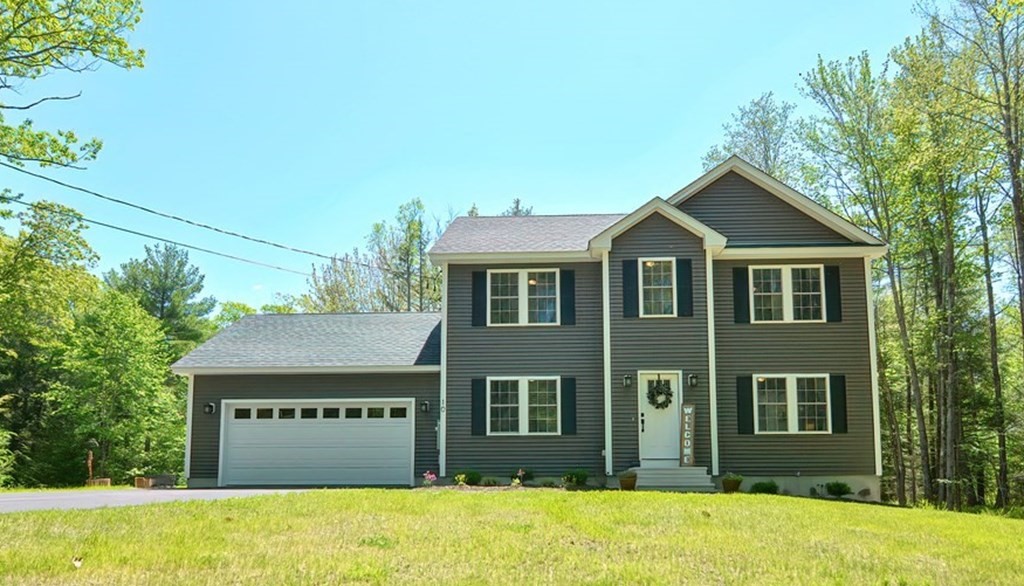a front view of a house with a yard