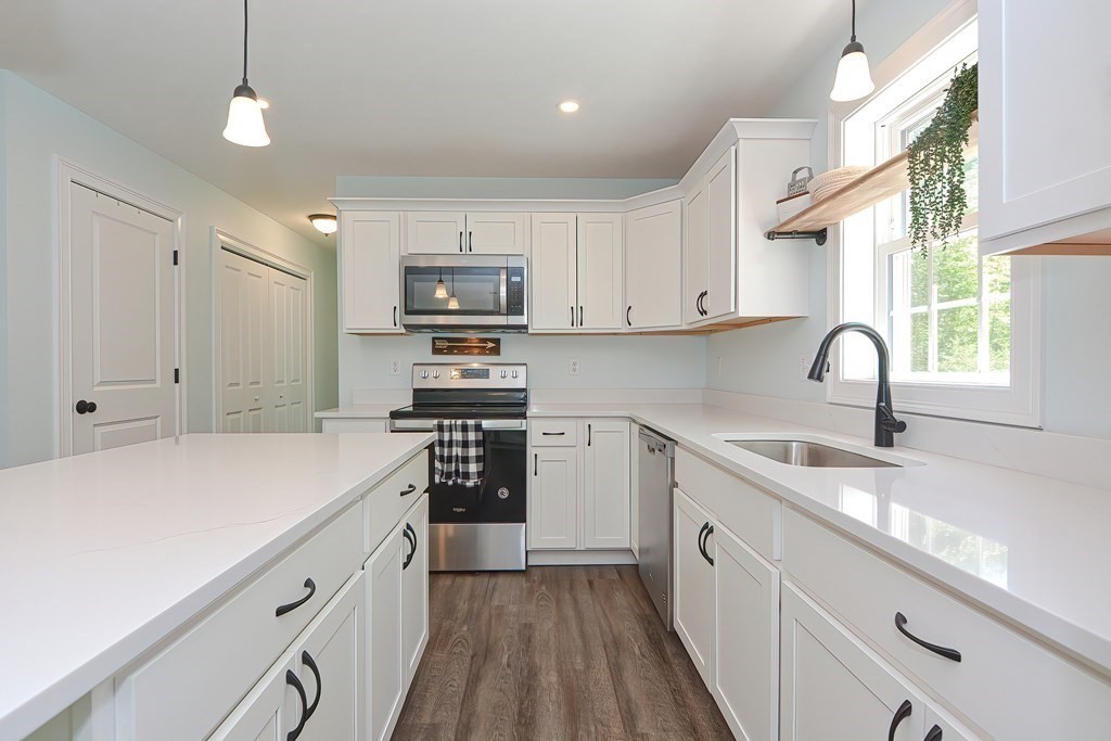 10 Colony Road Phillipston, MA 01331 - Photo 3 of 36 a kitchen with kitchen island white cabinets appliances and a sink