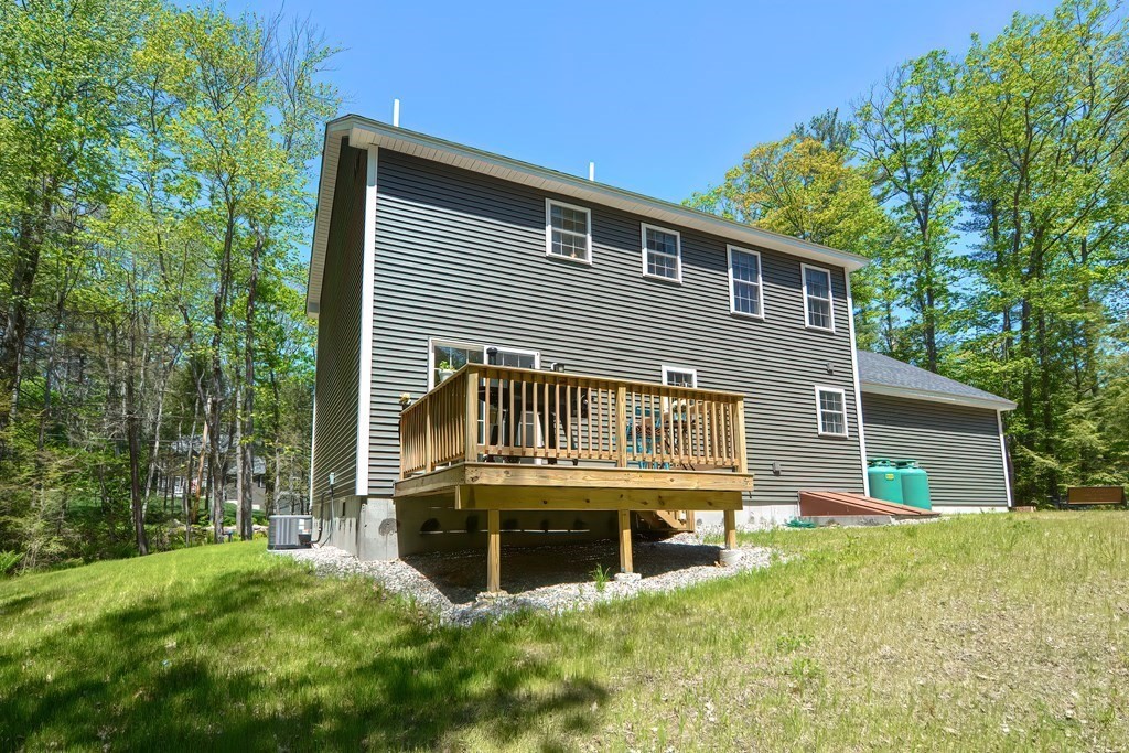 10 Colony Road Phillipston, MA 01331 - Photo 32 of 36 a backyard of a house with yard table and chairs