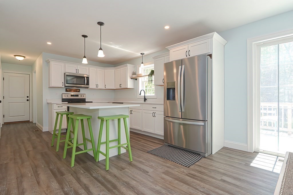 10 Colony Road Phillipston, MA 01331 - Photo 5 of 36 a kitchen with granite countertop stainless steel appliances a refrigerator and a stove top oven