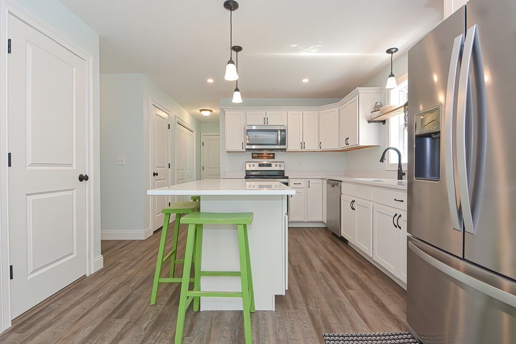 10 Colony Road Phillipston, MA 01331 - Photo 6 of 36 a kitchen with kitchen island white cabinets and stainless steel appliances