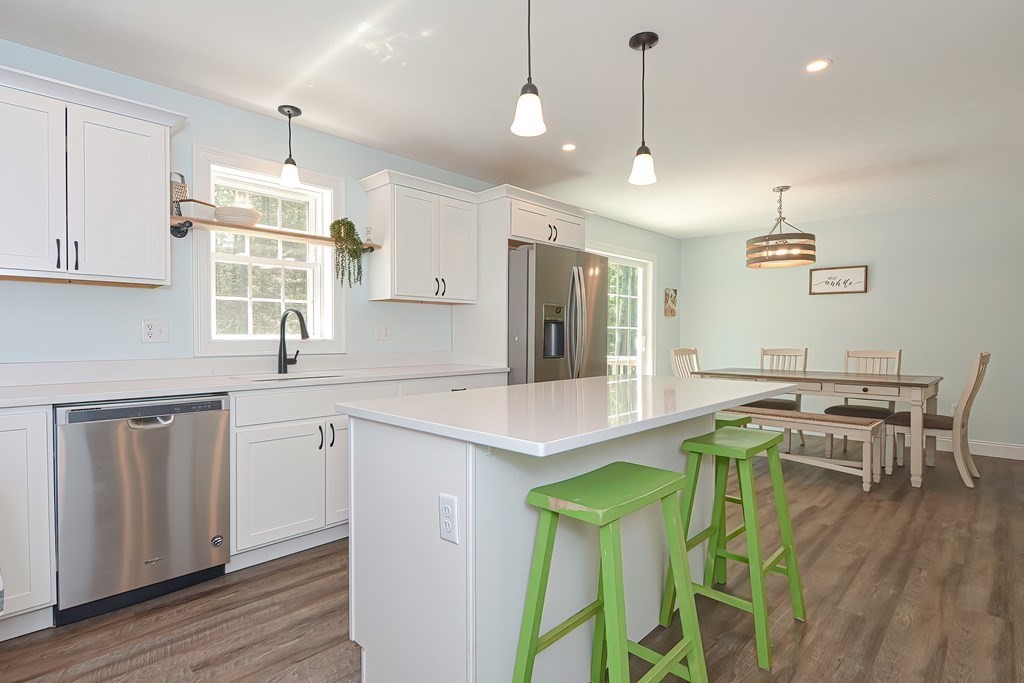 10 Colony Road Phillipston, MA 01331 - Photo 7 of 36 a kitchen with stainless steel appliances granite countertop a sink a stove a refrigerator and island with wooden floor