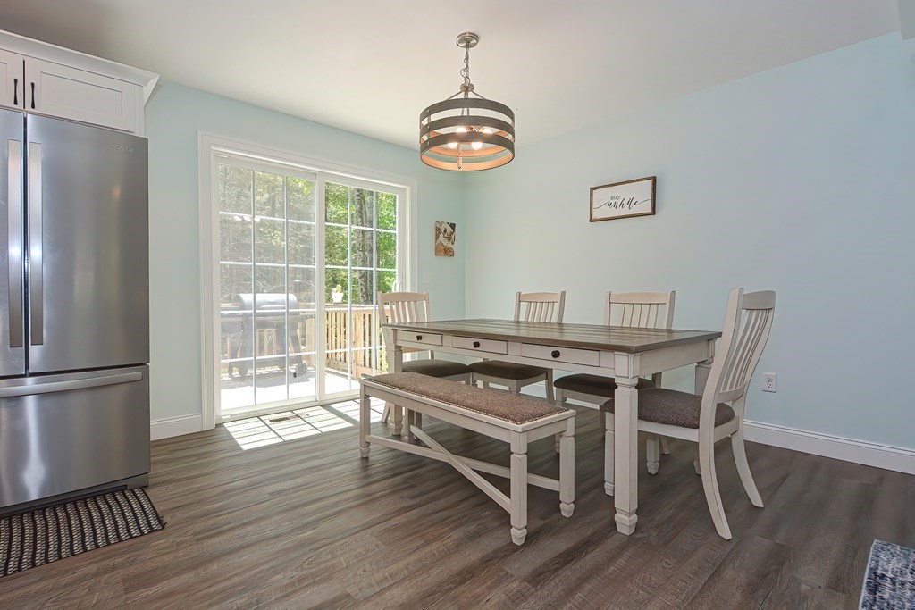 10 Colony Road Phillipston, MA 01331 - Photo 8 of 36 a dining room with wooden floor a chandelier a wooden table and chairs