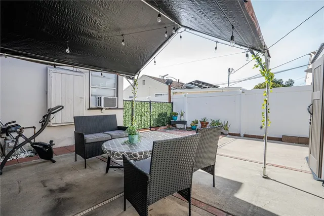 a view of a patio with a table and chairs