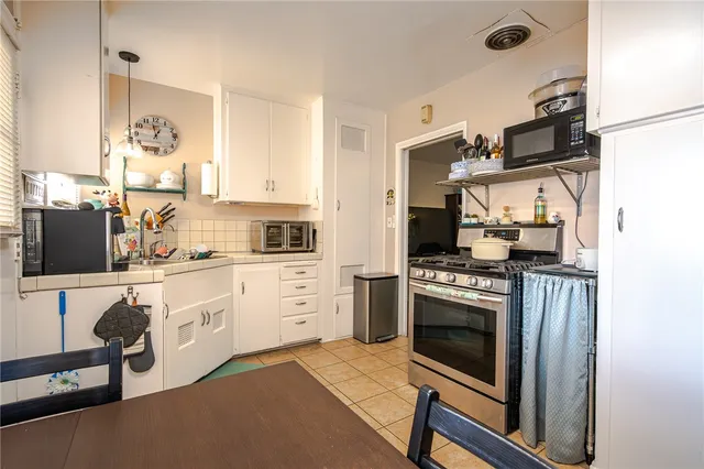 a kitchen with stainless steel appliances a stove a sink and a refrigerator
