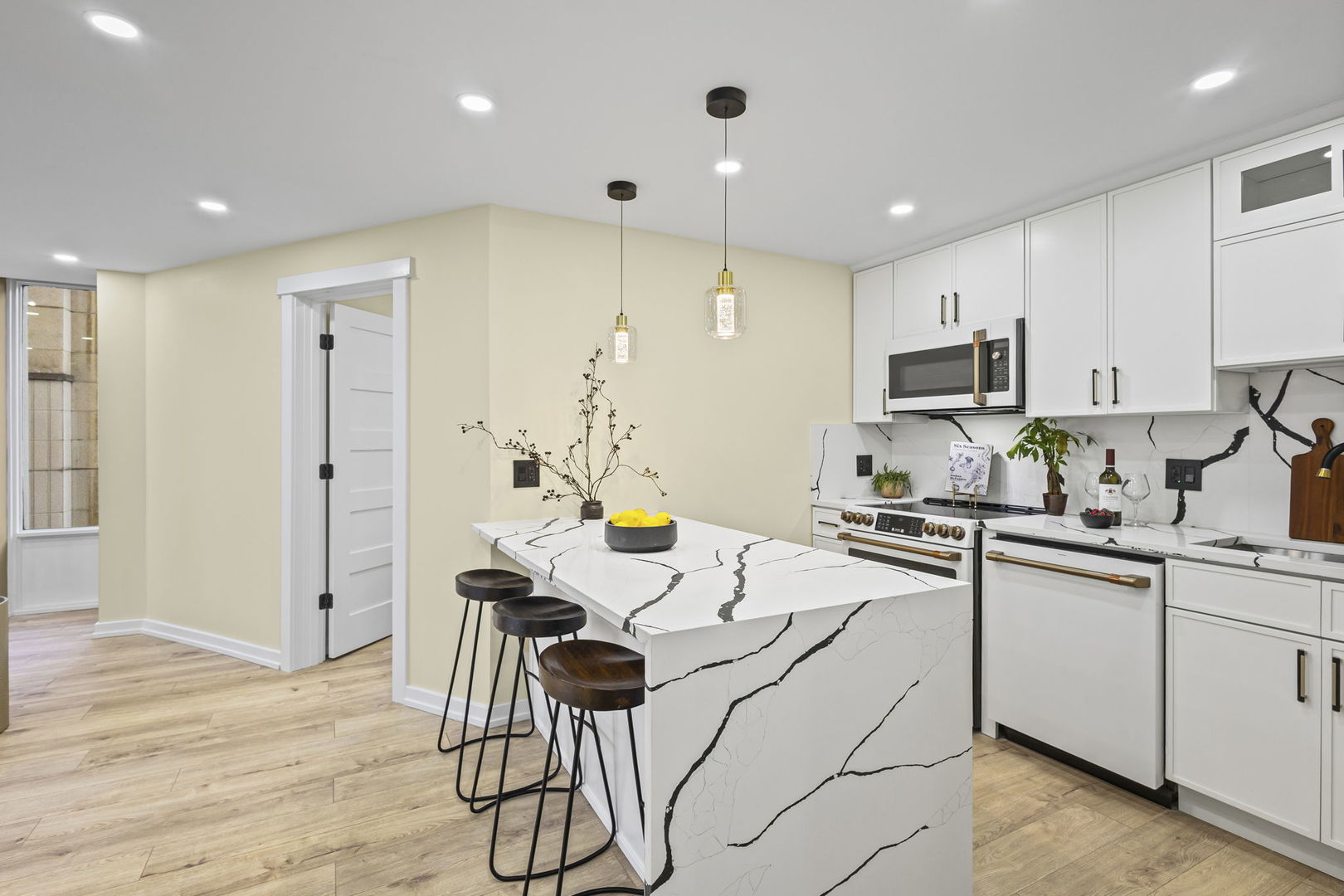 100 East Walton Street, Unit 14D Chicago, IL 60611 - Photo 11 of 36 a kitchen with stainless steel appliances a sink a stove a refrigerator cabinets and wooden floor