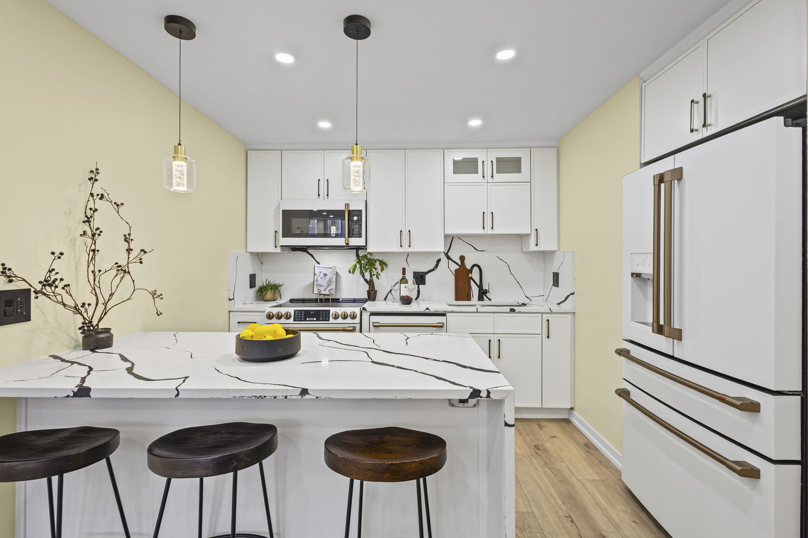 100 East Walton Street, Unit 14D Chicago, IL 60611 - Photo 14 of 36 a kitchen with stainless steel appliances granite countertop a sink a stove a refrigerator and white cabinets with wooden floor