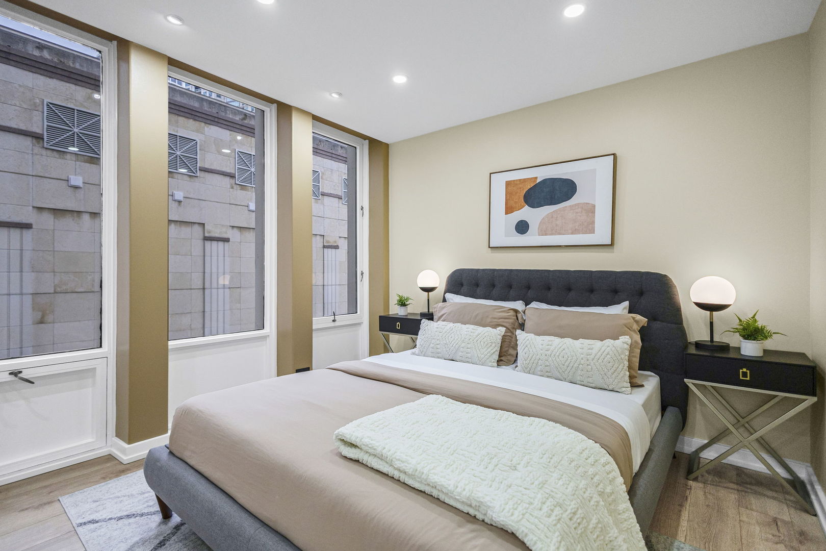 100 East Walton Street, Unit 14D Chicago, IL 60611 - Photo 18 of 36 a bedroom with a large bed and a painting on the wall