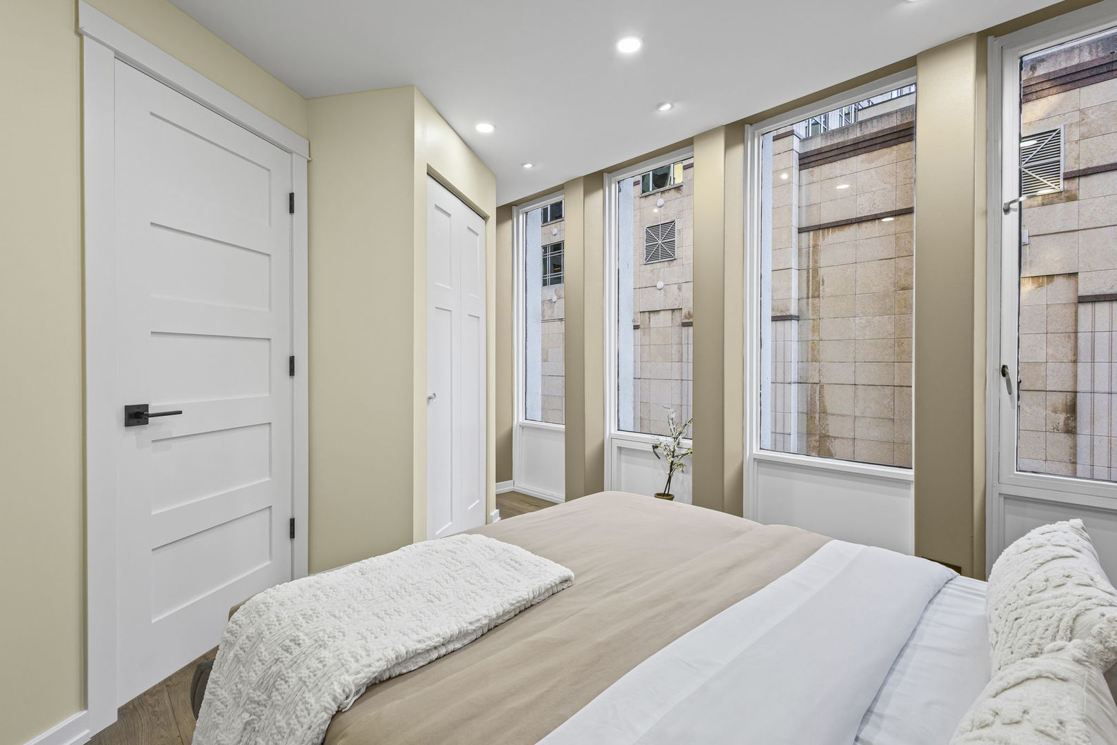 100 East Walton Street, Unit 14D Chicago, IL 60611 - Photo 19 of 36 a bedroom with a large bed and a glass door