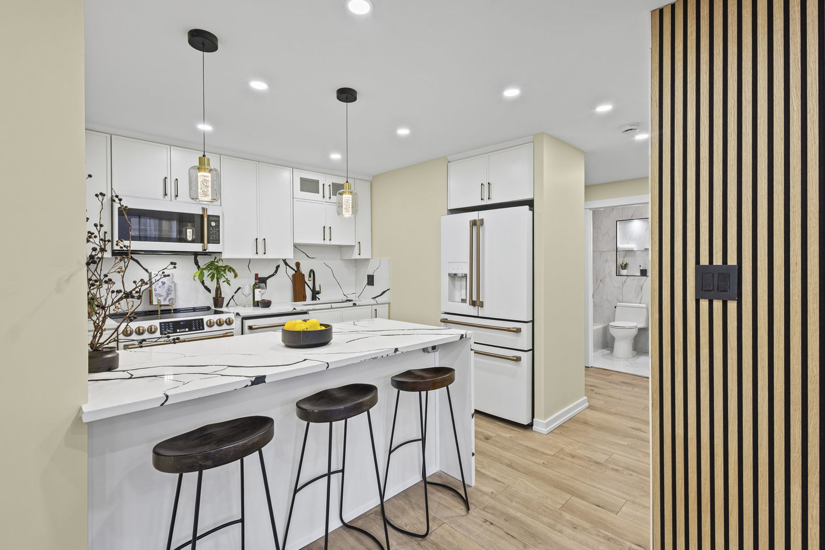 100 East Walton Street, Unit 14D Chicago, IL 60611 - Photo 8 of 36 a kitchen with stainless steel appliances granite countertop a refrigerator and a stove top oven