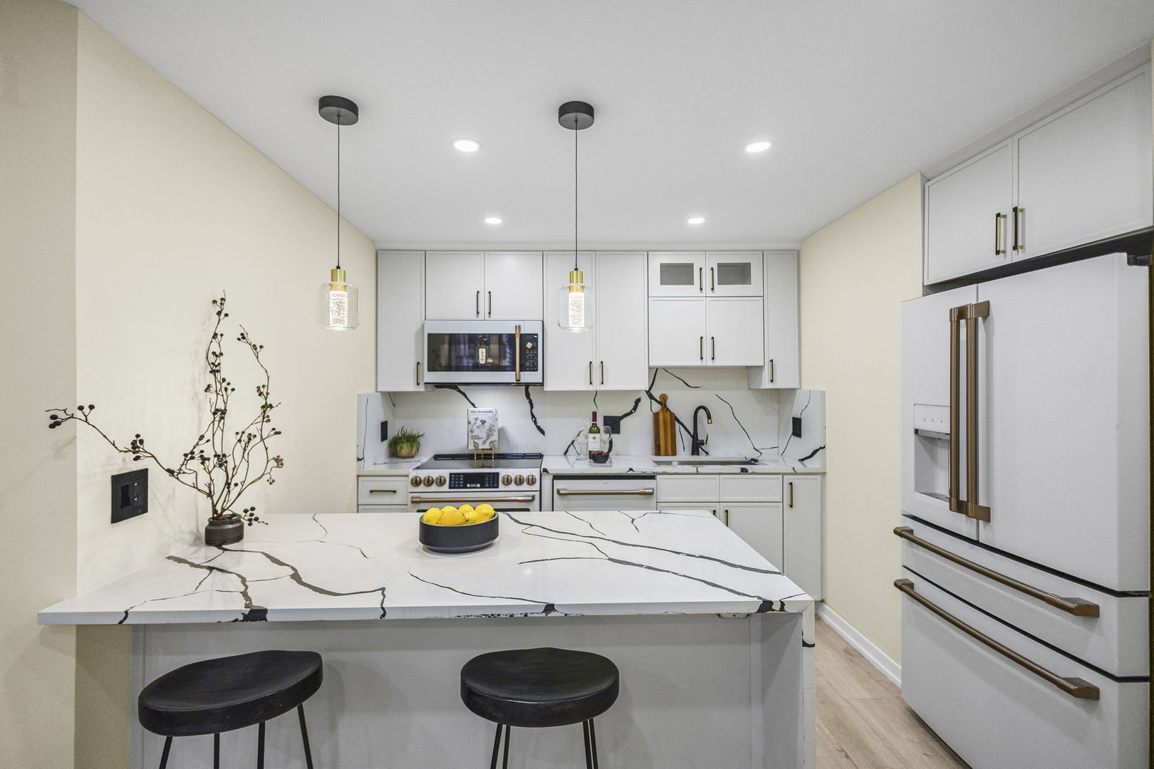 100 East Walton Street, Unit 14D Chicago, IL 60611 - Photo 10 of 36 a kitchen with stainless steel appliances granite countertop a sink and a refrigerator