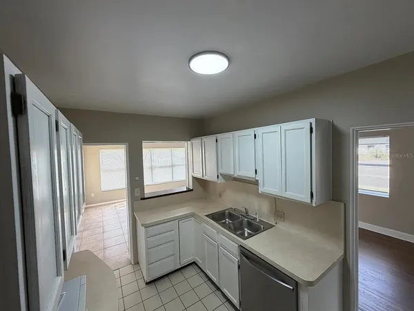 a kitchen with a stove a sink and a refrigerator