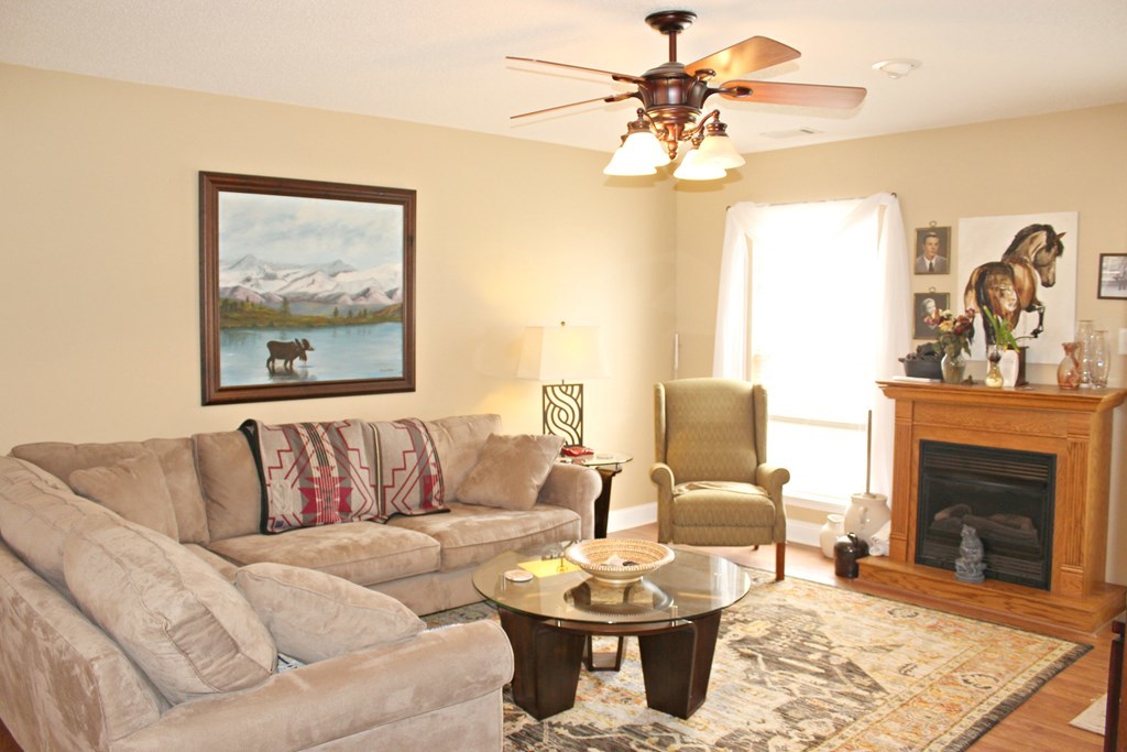 318 Lee King Road Forsyth, GA 31029 - Photo 2 of 8 a living room with furniture a fireplace and a flat screen tv