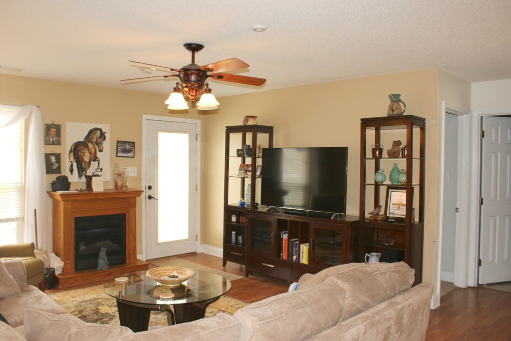 318 Lee King Road Forsyth, GA 31029 - Photo 3 of 8 a living room with furniture and a fireplace
