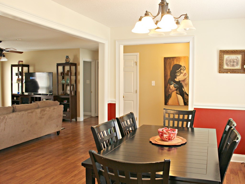 318 Lee King Road Forsyth, GA 31029 - Photo 6 of 8 a view of a dining room with furniture and wooden floor