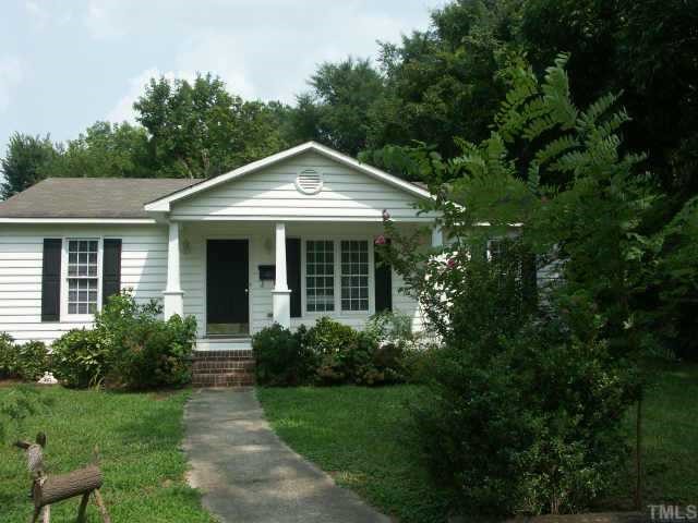 1002 Benjamin Street Raleigh, NC 27604 - Photo 1 of 1 a front view of a house with yard and green space