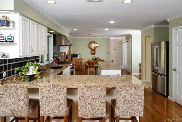 a view of a kitchen with dining table and chairs