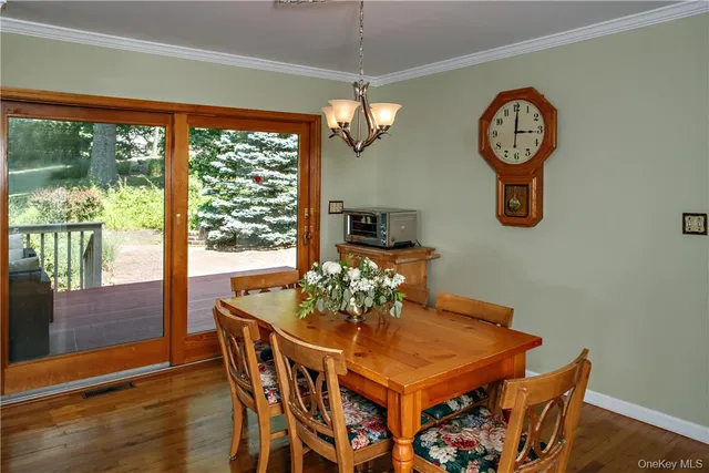 a dining room with furniture a potted plant and a chandelier
