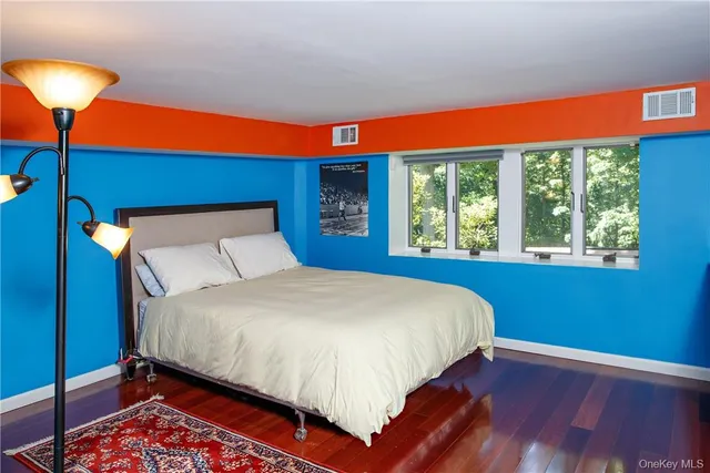 a large bed sitting in a bedroom next to a blue lamp