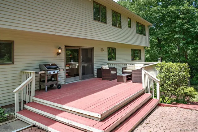a view of a patio with table and chairs and wooden fence