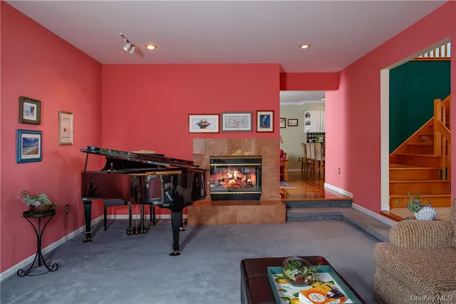 a living room with furniture a piano and a fireplace