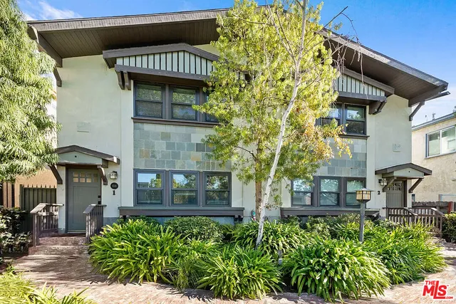 a view of a brick house with many windows