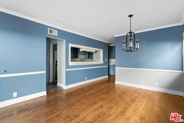 a view of a livingroom with a dishwasher cabinets and wooden floor