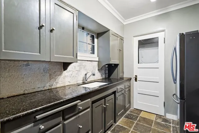 a kitchen with a refrigerator and countertop