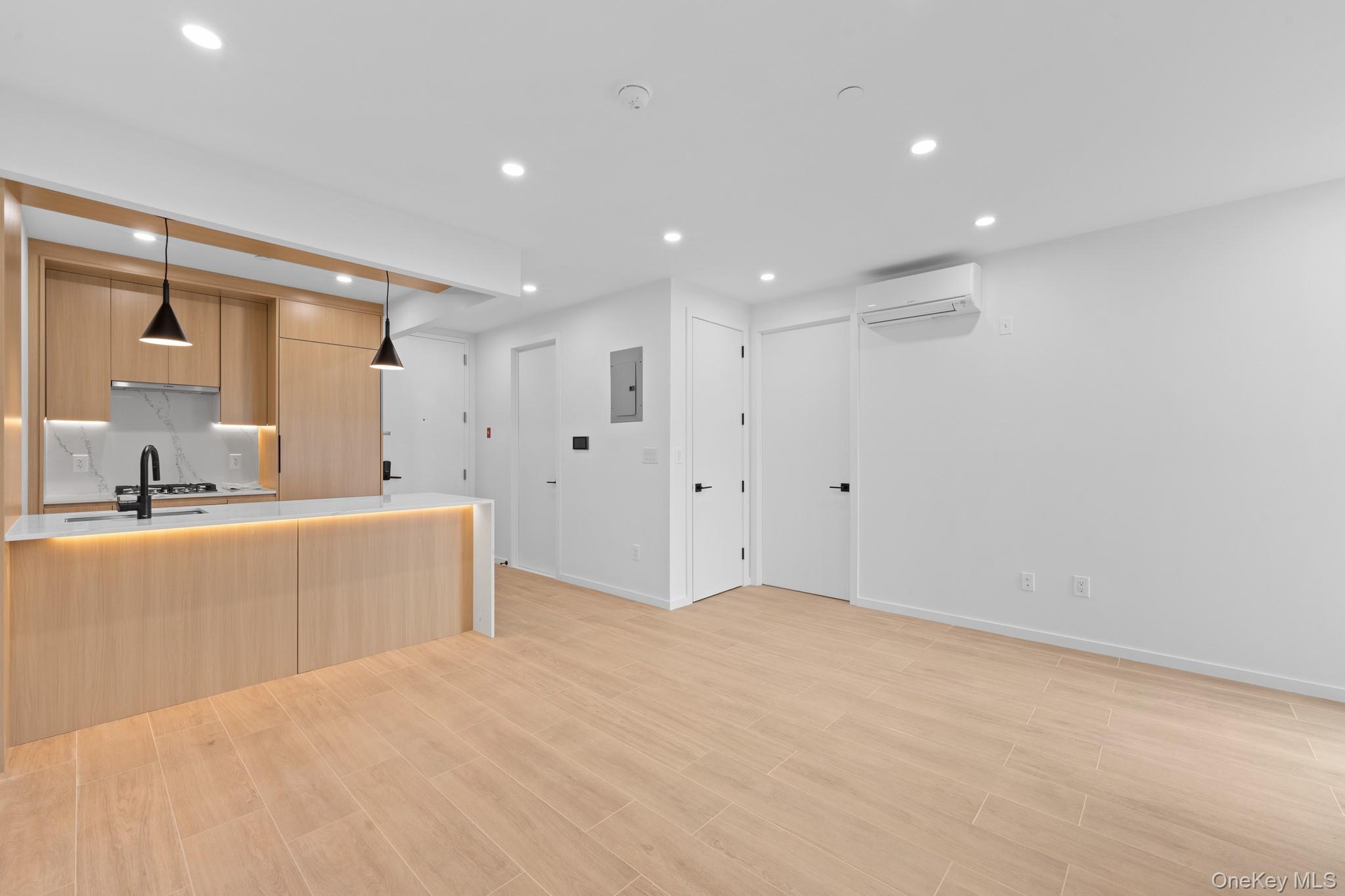 366 Harman Street, Unit 3R Brooklyn, NY 11237 - Photo 8 of 19 Kitchen with modern cabinets, light brown cabinetry, recessed lighting, decorative light fixtures, and light wood-style floors