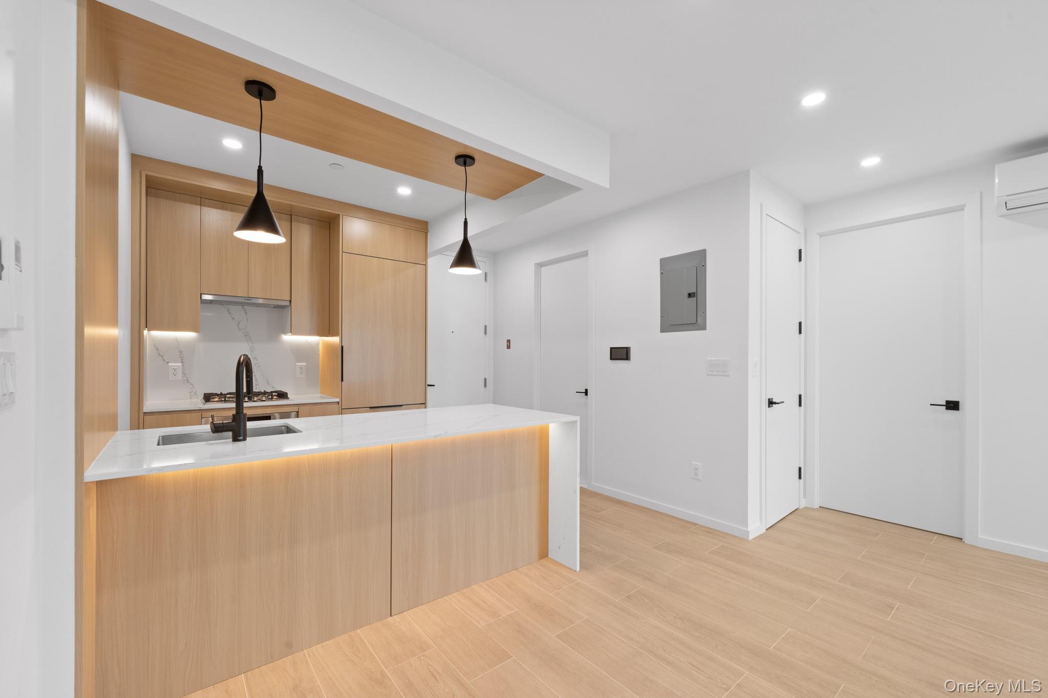 366 Harman Street, Unit 3R Brooklyn, NY 11237 - Photo 10 of 19 Kitchen featuring modern cabinets, light brown cabinetry, light stone countertops, recessed lighting, and wood finish floors