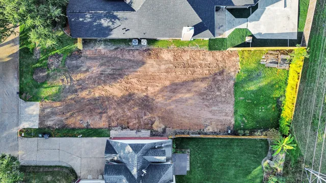 an aerial view of a house with a yard basket ball court and outdoor seating
