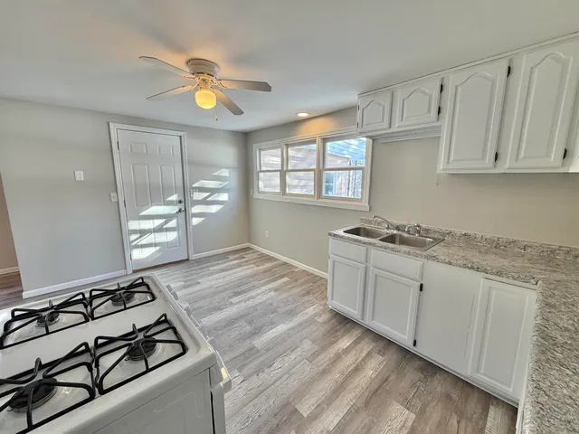 a view of a room with wooden floor and window