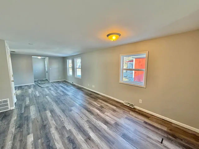 a kitchen with white cabinets and appliances